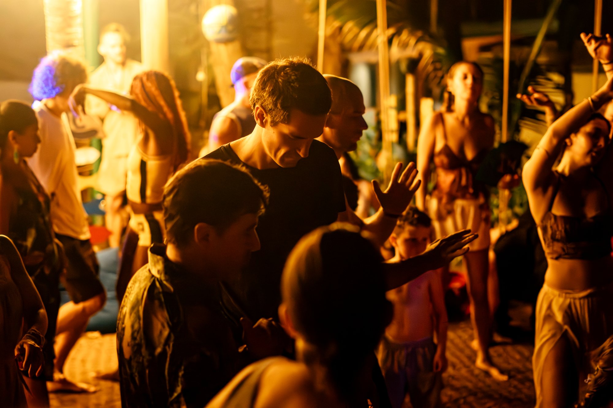 A full dance floor at Extaticaa in Hoi An, people dancing together in warm light